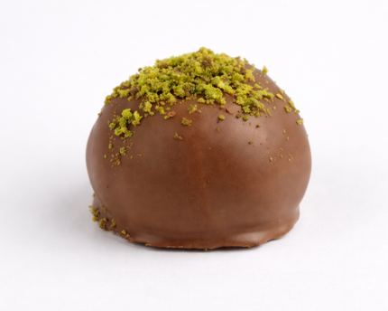 Loada Balls Chocolate pistachio protein ball close up on a white background.