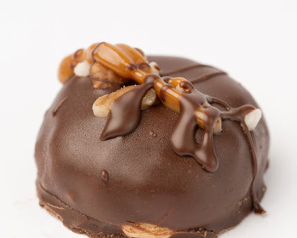 The Loada Balls Peanut Butter and Caramel protein ball close up product render on a white background.