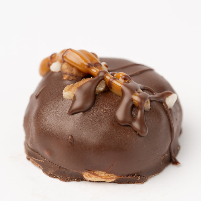 The Loada Balls Peanut Butter and Caramel protein ball close up product render on a white background.