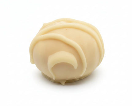 A single close up of the white chocolate peanut crunch protein ball by Loada Balls.