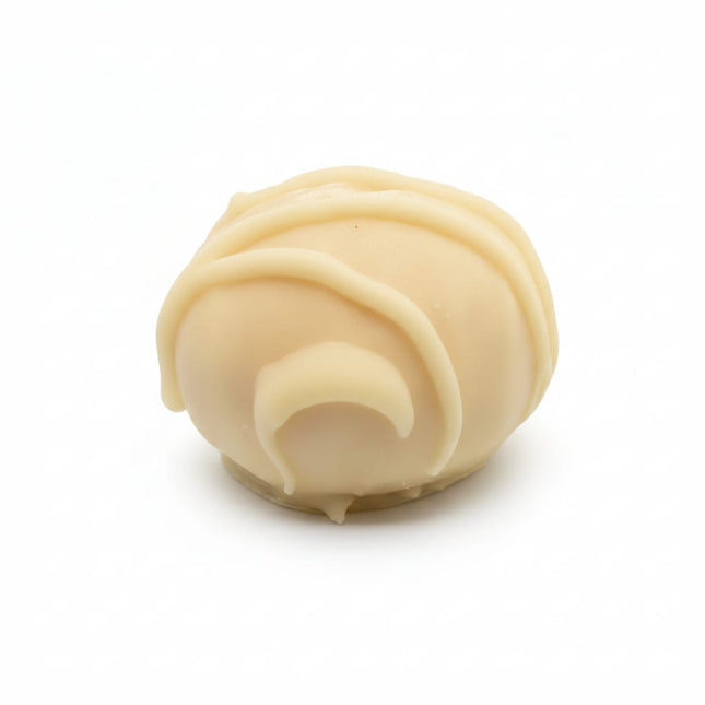 A single close up of the white chocolate peanut crunch protein ball by Loada Balls.