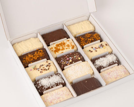 Assorted Loada balls protein bars in a white box on a light gray background