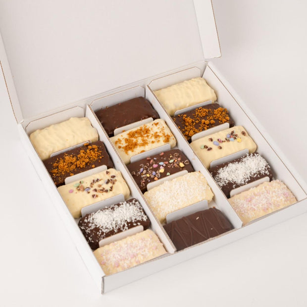 Assorted Loada balls protein bars in a white box on a light gray background