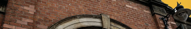 Brick building with ' St George's Market' sign and Loada Balls logo character with speech bubble saying "Come say hi!".