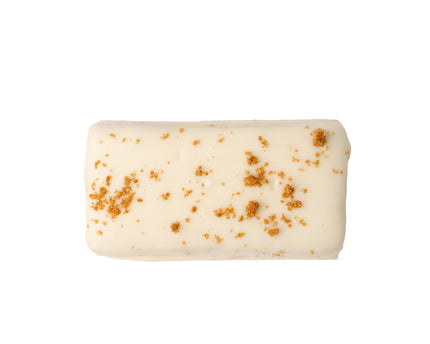 A close up product render of the Loada Balls White caramelised crumble protein bar on a white background.