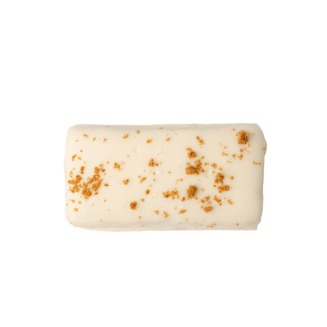 A close up product render of the Loada Balls White caramelised crumble protein bar on a white background.