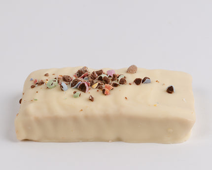 Loada Balls White Peanut Crunch Protein Bar on a grey background