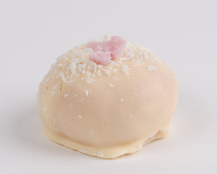 Loada Balls White Raspberry Coconut Protein ball close up on a white background.